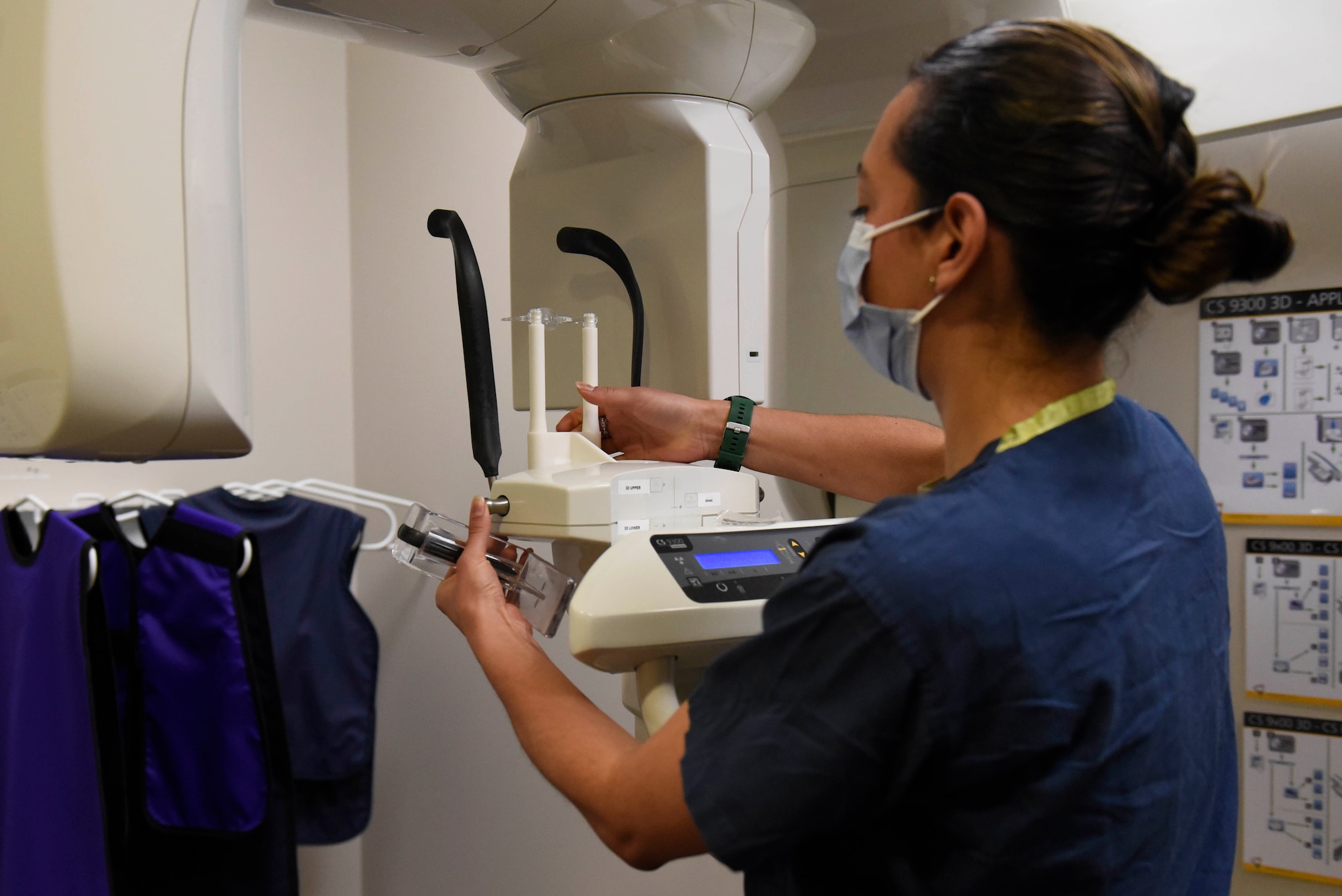 U.S. Air Force Tech Sgt. Ana Gomez-Martinez, 316th Wing Dental Squadron oral prophylaxis assistant, inserts a newly manufactured 3-D part for an X-ray machine, Joint Base Andrews, Md., Feb. 3, 2022.