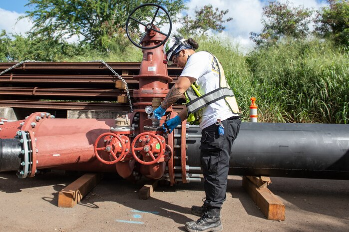 A Naval Facilities Engineering Systems Command contractor collects a water sample from Red Hill Well in support of Joint Base Pearl Harbor-Hickam’s (JBPHH) water restoration efforts.