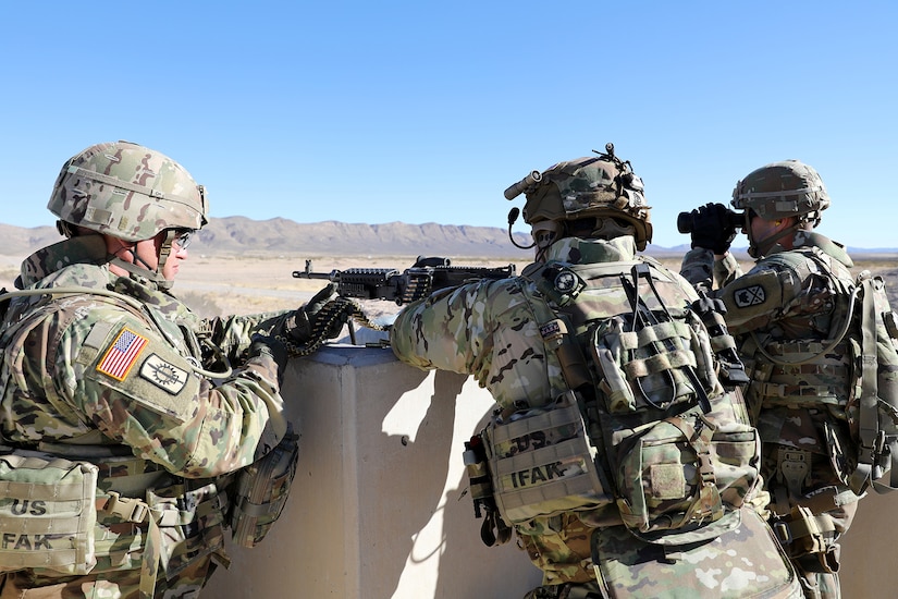 An M240 machine gun team from the 268th Military Police Company, of the Tennessee National Guard fires at targets, while observed by observer coach/trainers assigned to the 3-360th Training Support Battalion, during a range training exercise at Fort Bliss, Texas.
