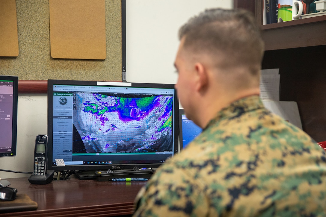 U.S. Marine Corps Sgt. Nathaniel Cunningham, a meteorology and oceanography (METOC) analyst forecaster with Marine Corps Air Facilities Quantico, checks weather radar images on his computer at Marine Corps Base Quantico, Virginia, Jan. 26, 2022. METOC provides meteorological support to aircrews, pilots, training units, and the base commander by delivering up-to-date and accurate weather forecasts and conditions, promoting safe operations across the base. (US Marine Corps photo by Lance Cpl. Kayla LaMar)