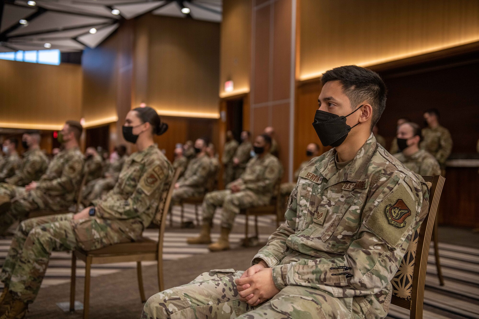 Airmen sit in attendance at a meeting