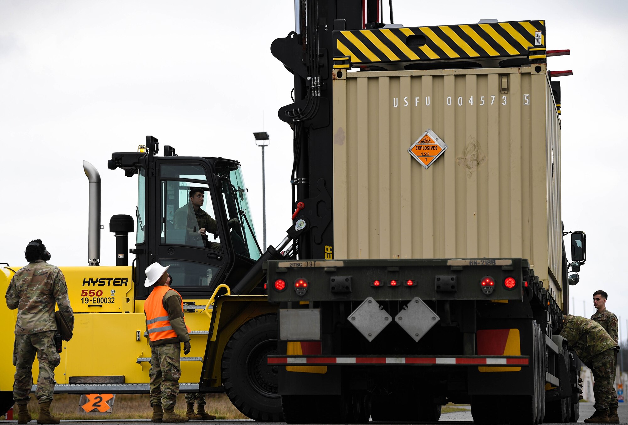 Airmen from the 86th Munitions Squadron transport a crate of munitions at Ramstein Air Base, Germany, Feb. 4, 2022. 86 MUNS personnel safely placed munitions cargo on the back of a semi truck destined for another base. (U.S. Air Force photo by Airman 1st Class Jared Lovett)