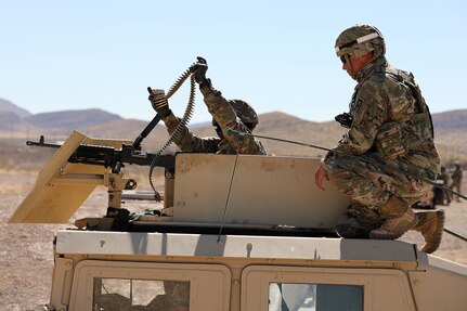 Sgt. Javier Stoneburner, observer coach/ trainer from the 85th U.S. Army Reserve Support Command’s 3-360th Training Support Battalion, observes a Tennessee National Guard Soldier from the 268th Military Police Company load ammunition into an M240 machine gun during a range training exercise at Fort Bliss, Texas. The three-day exercise challenged Soldiers to identify targets and coordinate a response between the tower, base defense operations cell and the quick reaction force.