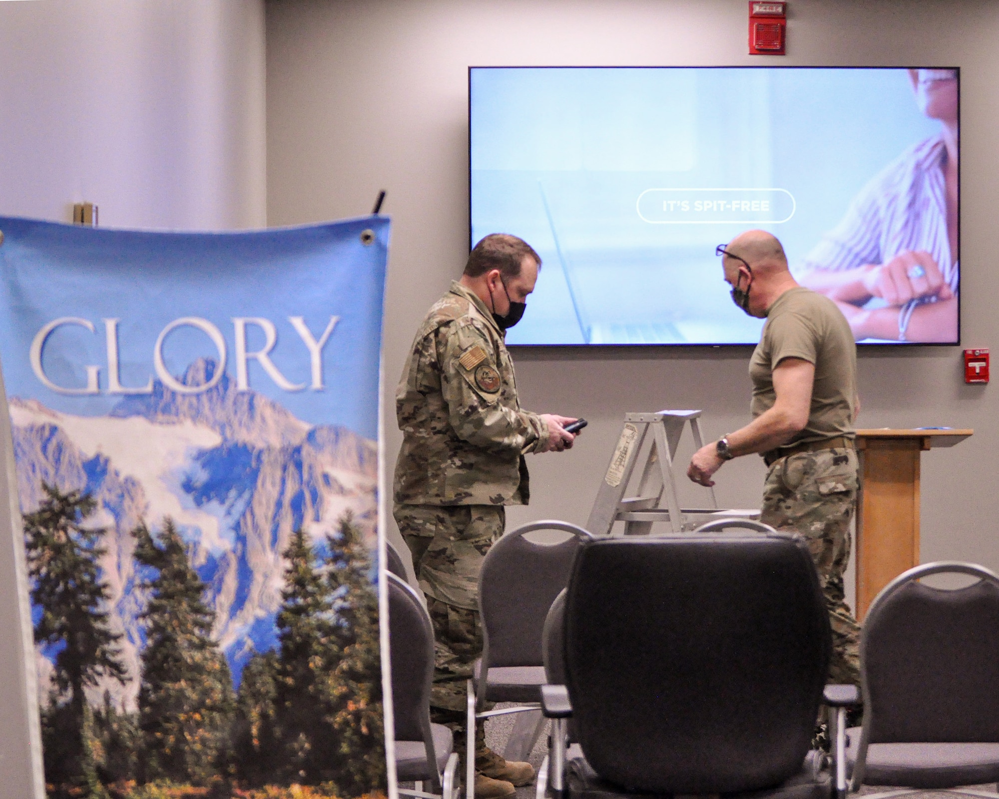 Chaplain (Maj.) Luke McKeeth, 445th Airlift Wing Chaplain Corps, and Chief Master Sgt. Alan Baker, 445th Civil Engineer Squadron, install high definition multimedia interface cable in the wing chaplain office Jan. 9, 2022,