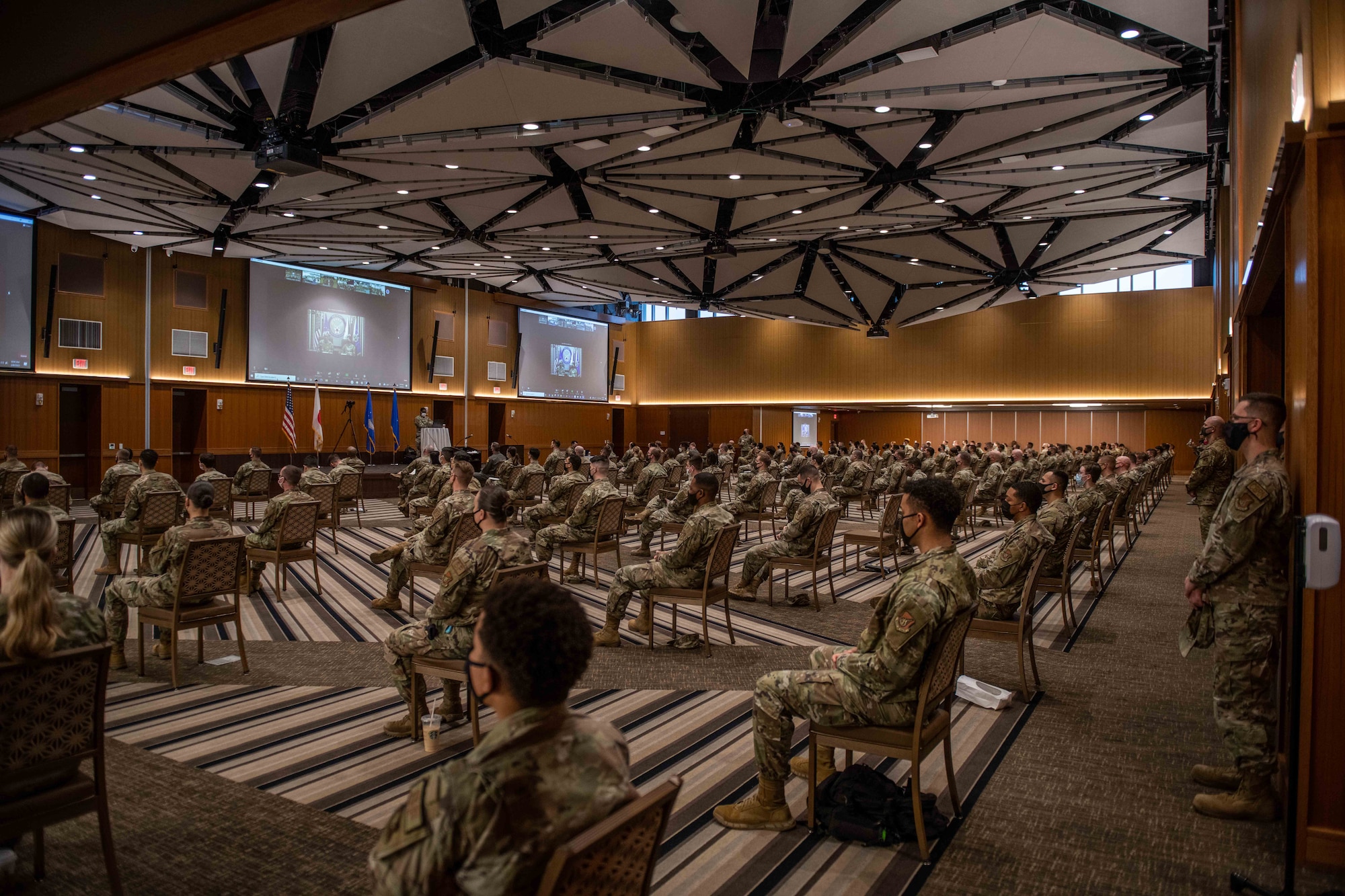 Airmen from the 18th Wing and 353rd Special Operations Wing attend a virtual all-call hosted by Air Force Chief of Staff Gen. CQ. Brown, Jr., and Chief Master Sgt. of the Air Force JoAnne S. Bass at Kadena Air Base, Japan, Feb. 8, 2022. During the all-call, Brown and Bass spoke about modernizing the Air Force, investing in and empowering Airmen, and preparing to tackle new warfighting domains of space and cyberspace. (U.S. Air Force photo by Airman 1st Class Cesar J. Navarro)