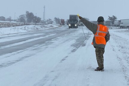 Private 1st Class Brandon Victor, of Monee, Troop A, 2nd Battalion, 106th Cavalry Regiment, directs traffic while Illinois State Police assist motorists Feb. 3.