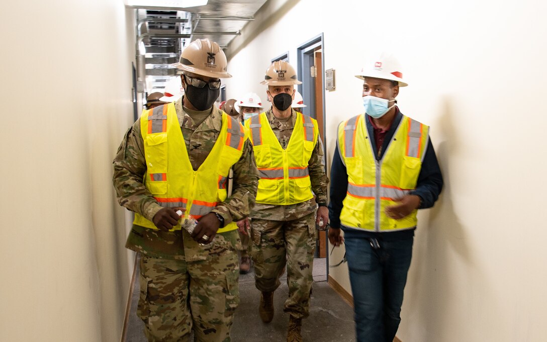 The Transatlantic Middle East District Commander Colonel Philip Secrist, along with Carlos Estrella, the area engineer, and Issa Dioubate, the project engineer, brief Lt. Gen. Scott A. Spellmon, the 55th Chief of Engineers and commanding general of U.S. Army Corps of Engineers, on renovation project for building 550 South, located at Camp Arifjan, Kuwait, on 31 Jan. When completed with new entry control points, cubicles, office space, secure communications, and heating and air-conditioning, the former warehouse will support multiple commands with