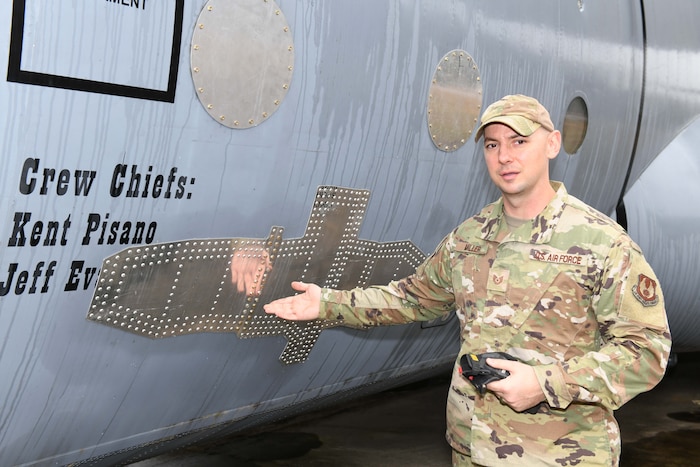 Military person pointing to aircraft