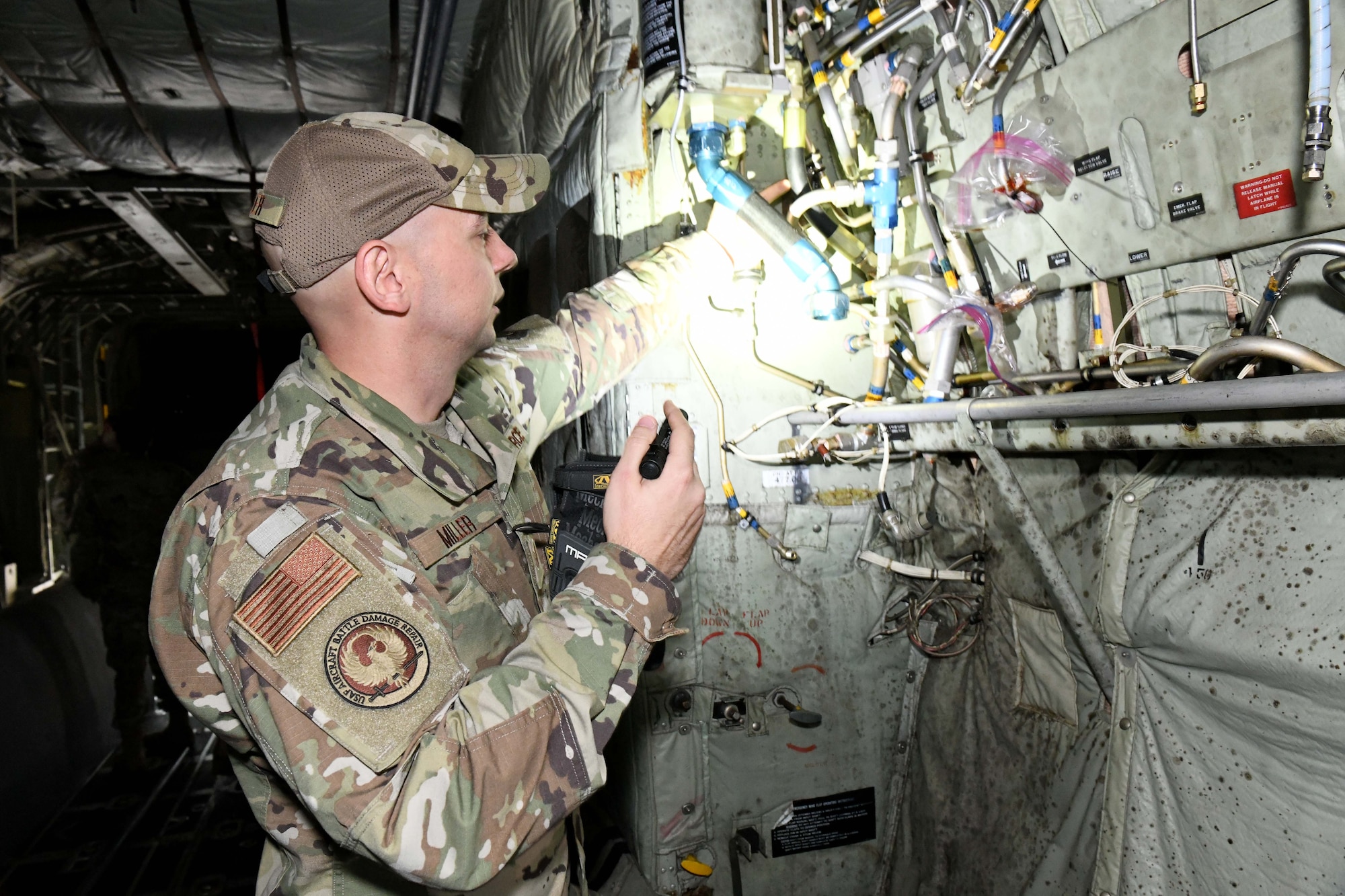 Military member inspecting wire