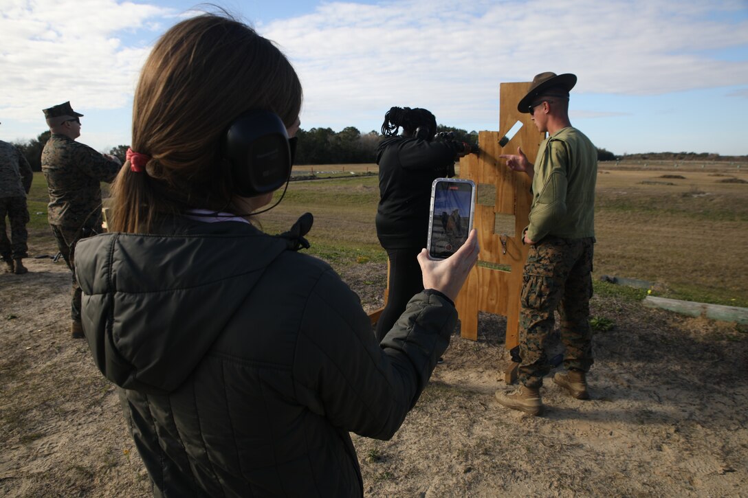 Emily Pettaway, the dean of academics for St. Louis Catholic High School of Lake Charles, Louisiana, takes a video of Kayla Jackson, an Algebra I teacher at Ponchatoula High School of Ponchatoula, Louisiana, firing an M16A4 service rifle during an Educators Workshop aboard Marine Corps Recruit Depot Parris Island, S.C., January 12, 2022.
