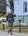 U.S Army Spc. Deedra Irwin, 86th Troop Command, finishes strong on the ruck portion during the Vermont best warrior competition at Ethan Allen Firing Range, April 10, 2021.Spc. Deedra Irwin, the Vermont National Guard's Soldier of the Year, placed seventh in the U.S. Olympic Biathlon's women's 15k individual race in February 2022. (U.S. Army National Guard photo by Sgt. Devin Nuñez)