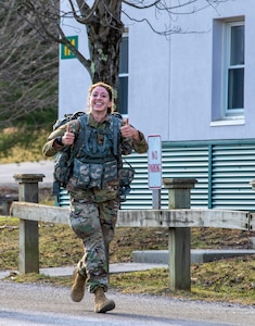 U.S Army Spc. Deedra Irwin, 86th Troop Command, finishes strong on the ruck portion during the Vermont best warrior competition. at Ethan Allen Firing Range, April 10, 2021.Spc. Deedra Irwin, the Vermont National Guard's Soldier of the Year, placed seventh in the U.S. Olympic Biathlon's women's 15k individual race in February 2022. (U.S. Army National Guard photo by Sgt. Devin Nuñez)