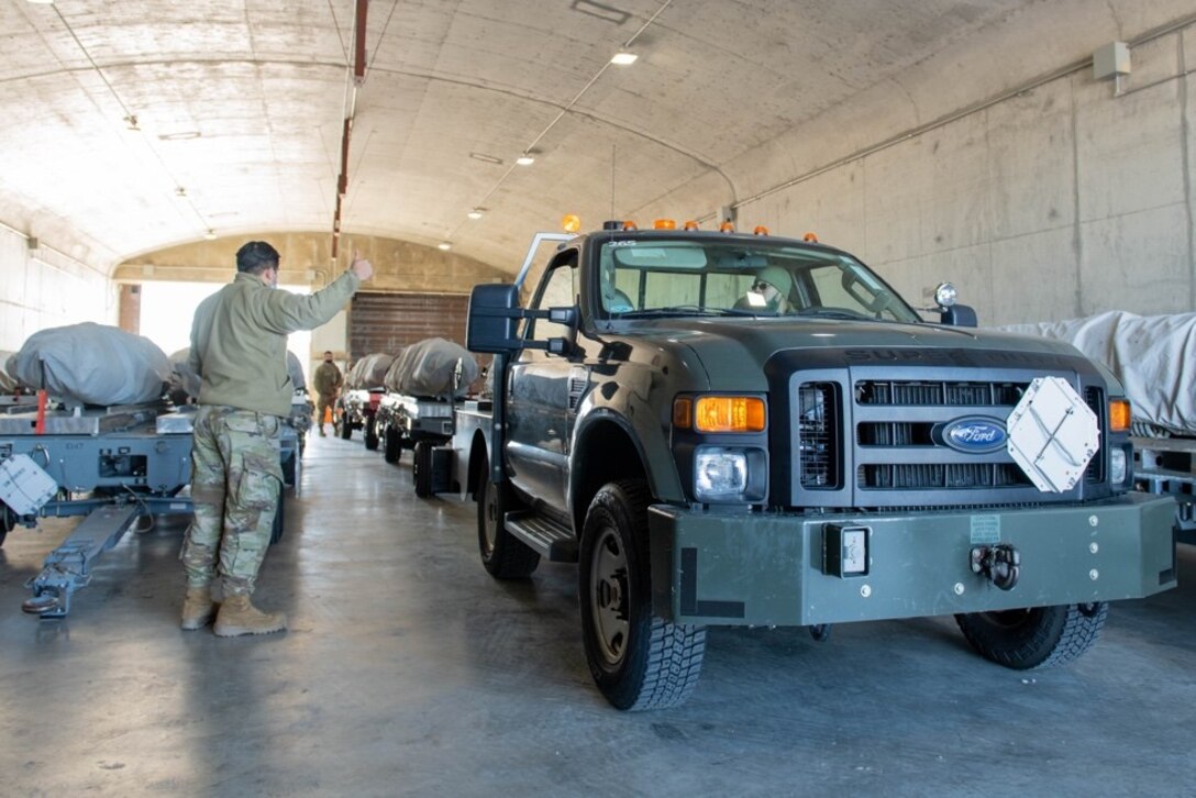 Senior Airman Steven Gonzales, 28th Munitions Squadron line delivery technician, and Airman 1st Class Raymond Claudio, 28th Munitions Squadron line delivery technician driver, store dummy air training missiles at Ellsworth Air Force Base, S.D., Feb. 4, 2022.