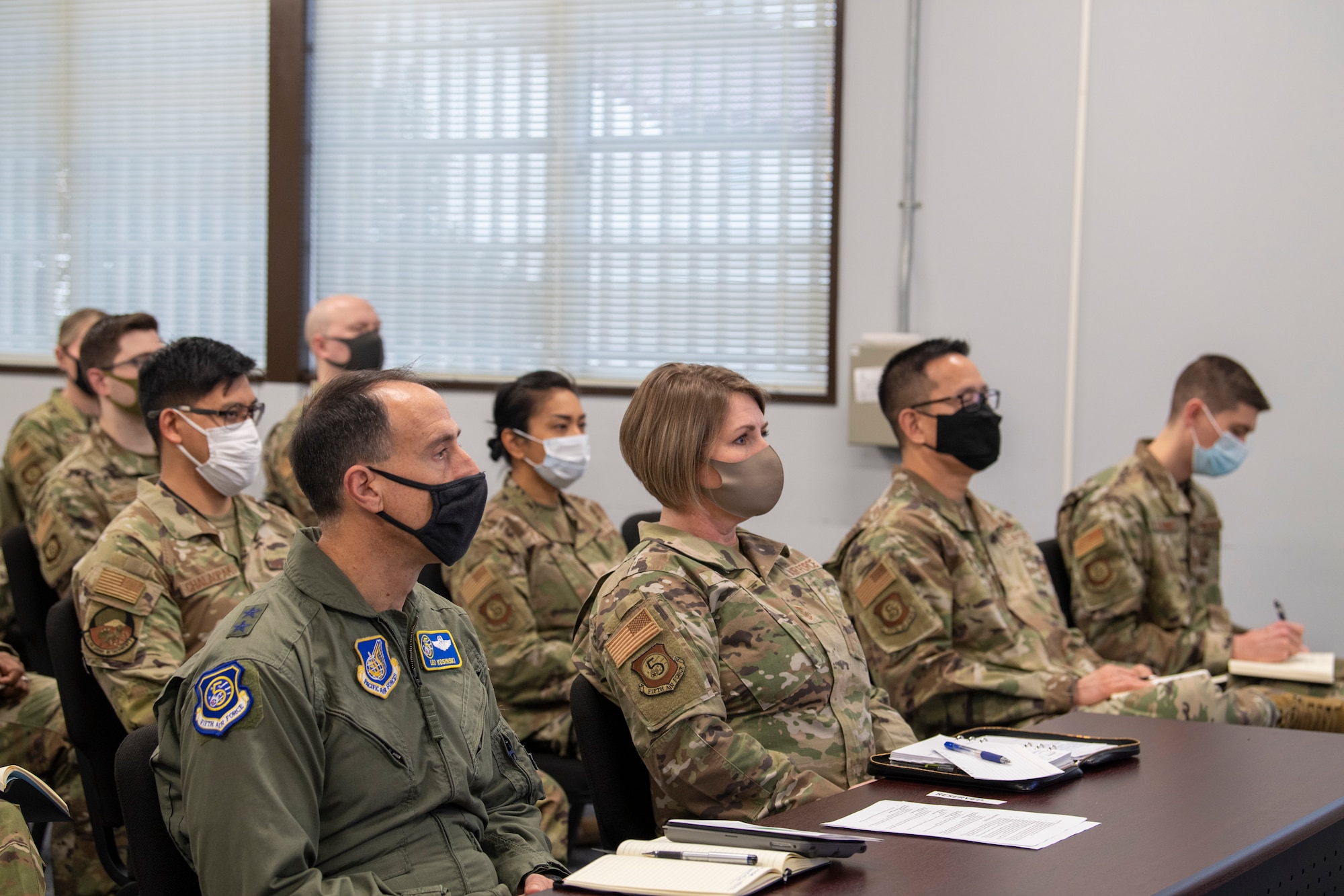 Maj. Gen. Leonard Kosinski, 5th Air Force deputy commander, and Chief Master Sgt. Kathleen McCool, 5th Air Force command chief, attend the virtual all-call with Air Force Chief of Staff Gen. CQ  Brown, Jr., and Chief Master Sgt. of the Air Force JoAnne S. Bass Feb. 8, 2022, at Yokota Air Base, Japan. Participants were recognized for their achievements and able to engage with Brown and Bass in a live Q&A. (U.S. Air Force photo by Senior Airman Brieana E. Bolfing)