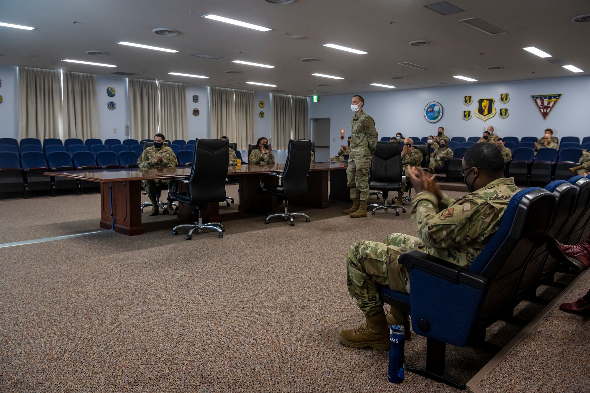 Airmen cheering for another Airmen who was recognized for his outstanding work.