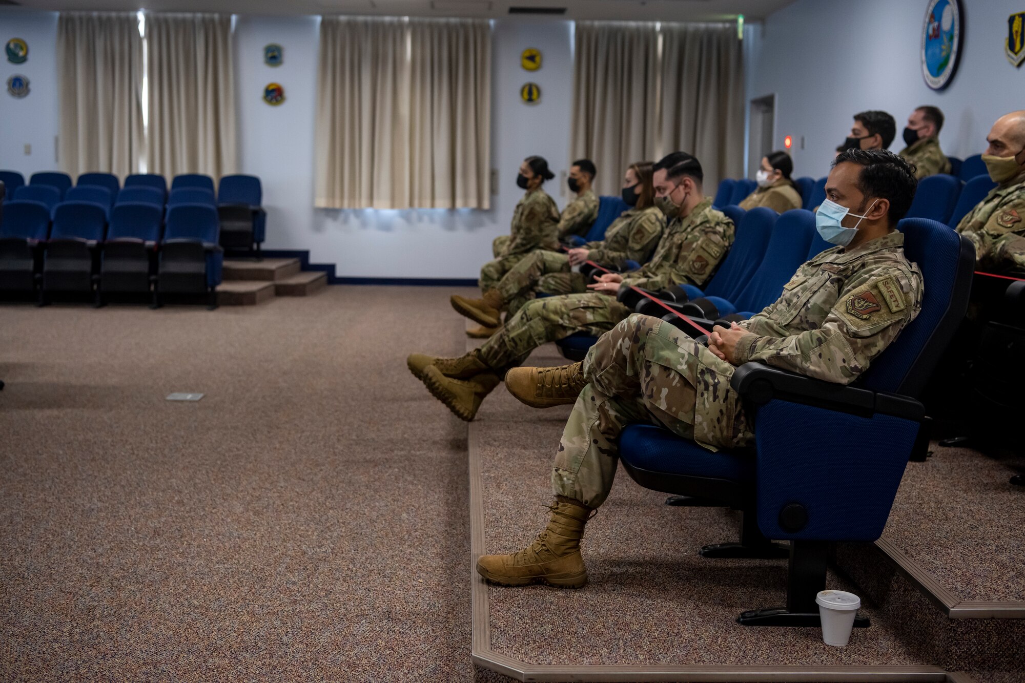 Airmen sitting in a conference room.