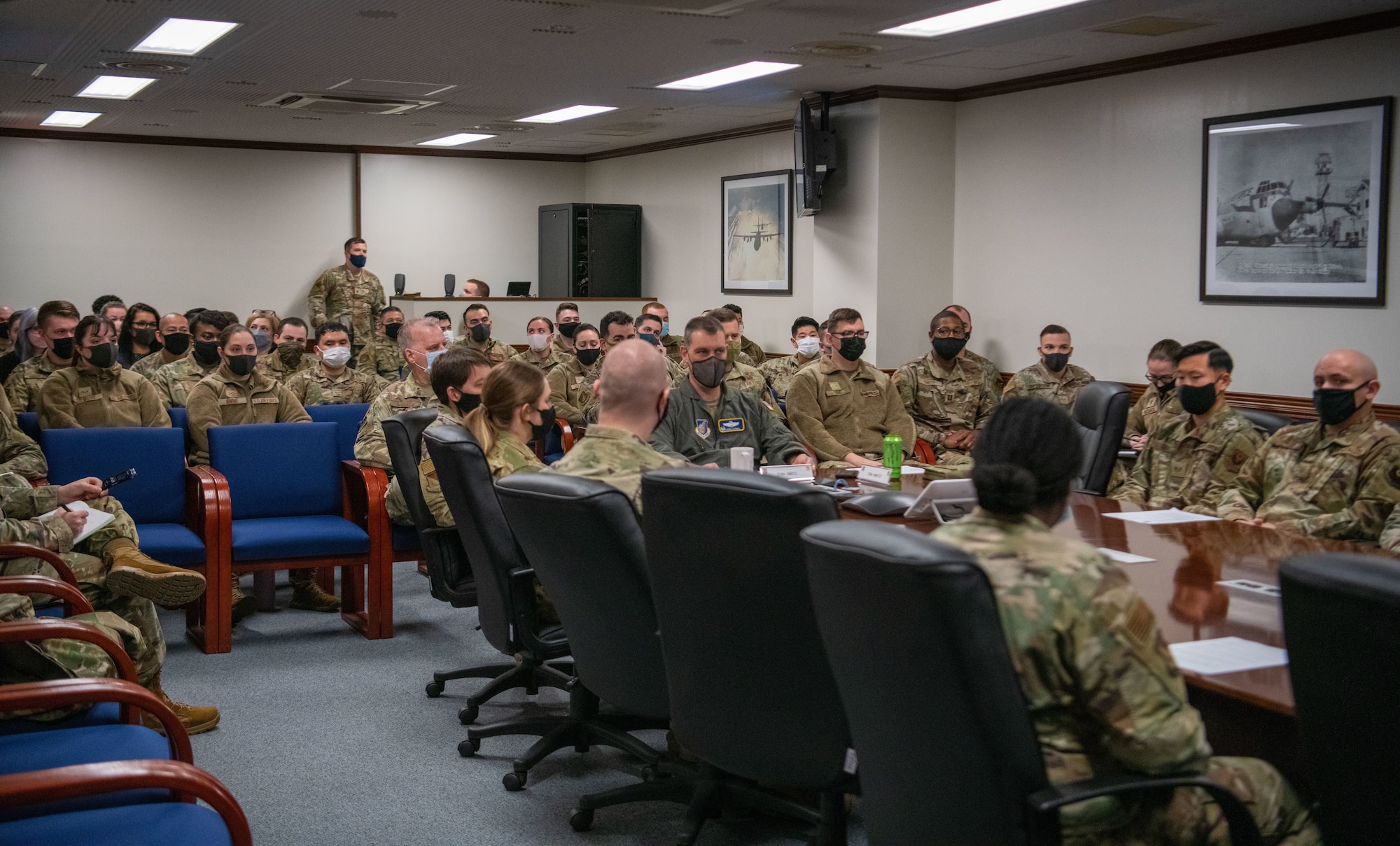 Airmen from the 374th Airlift Wing gather in the wing conference room to attend a virtual all-call with Air Force Chief of Staff Gen. CQ Brown, Jr., and Chief Master Sgt. of the Air Force JoAnne S. Bass Feb. 8, 2022, at Yokota Air Base, Japan.