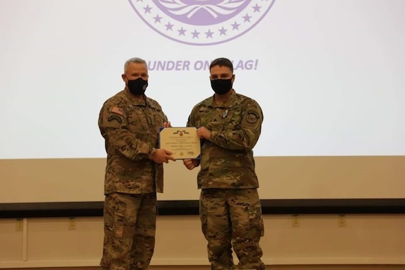 UNC Commander presents a JSAM to a member of the UNCJSA at the UNC Town Hall Awards Ceremony.