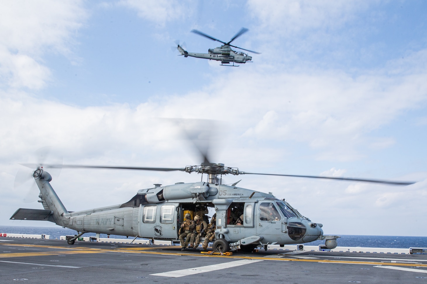 PHILIPPINE SEA (Feb. 5, 2022) U.S. Marines with Maritime Raid Force, 31st Marine Expeditionary Unit (MEU), prepare for takeoff aboard the amphibious assault ship USS America (LHA 6) prior to a Visitation, Board, Search, and Seizure (VBSS) during operation Noble Fusion in the Philippine Sea, Feb. 5, 2022. VBSS training reinforces the Marine Corps’ presence within ocean waters by having a team at the ready to act in a moment’s notice. Noble Fusion demonstrates that Navy and Marine Corps forward-deployed stand-in naval expeditionary forces can rapidly aggregate Marine Expeditionary Unit/Amphibious Ready Group teams at sea, along with a carrier strike group, joint forces and allies in order to conduct lethal sea-denial operations, seize key maritime terrain, guarantee freedom of movement, and create advantage for US, partner and allied forces. Naval Expeditionary forces conduct training throughout the year, in the Indo-Pacific, to maintain readiness. (U.S. Marine Corps photo by Lance Cpl. Malik Lewis)