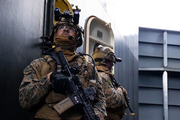 PHILIPPINE SEA (Feb 5, 2022) U.S. Marines with Maritime Raid Force, 31st Marine Expeditionary Unit (MEU), clear a passageway aboard the USS Miguel Keith (ESB 5) during a Visit, Board, Search, and Seizure (VBSS) during operation Noble Fusion in the Philippine Sea, Feb. 5, 2022. VBSS training reinforces the Marine Corps’ presence within ocean waters by having a team at the ready to act in a moment’s notice. Noble Fusion demonstrates that Navy and Marine Corps forward-deployed stand-in naval expeditionary forces can rapidly aggregate Marine Expeditionary Unit/Amphibious Ready Group teams at sea, along with a carrier strike group, joint forces and allies in order to conduct lethal sea-denial operations, seize key maritime terrain, guarantee freedom of movement, and create advantage for US, partner and allied forces. Naval Expeditionary forces conduct training throughout the year, in the Indo-Pacific, to maintain readiness. (U.S. Marine Corps photo by Lance Cpl. Cesar Ronaldo Alarcon)