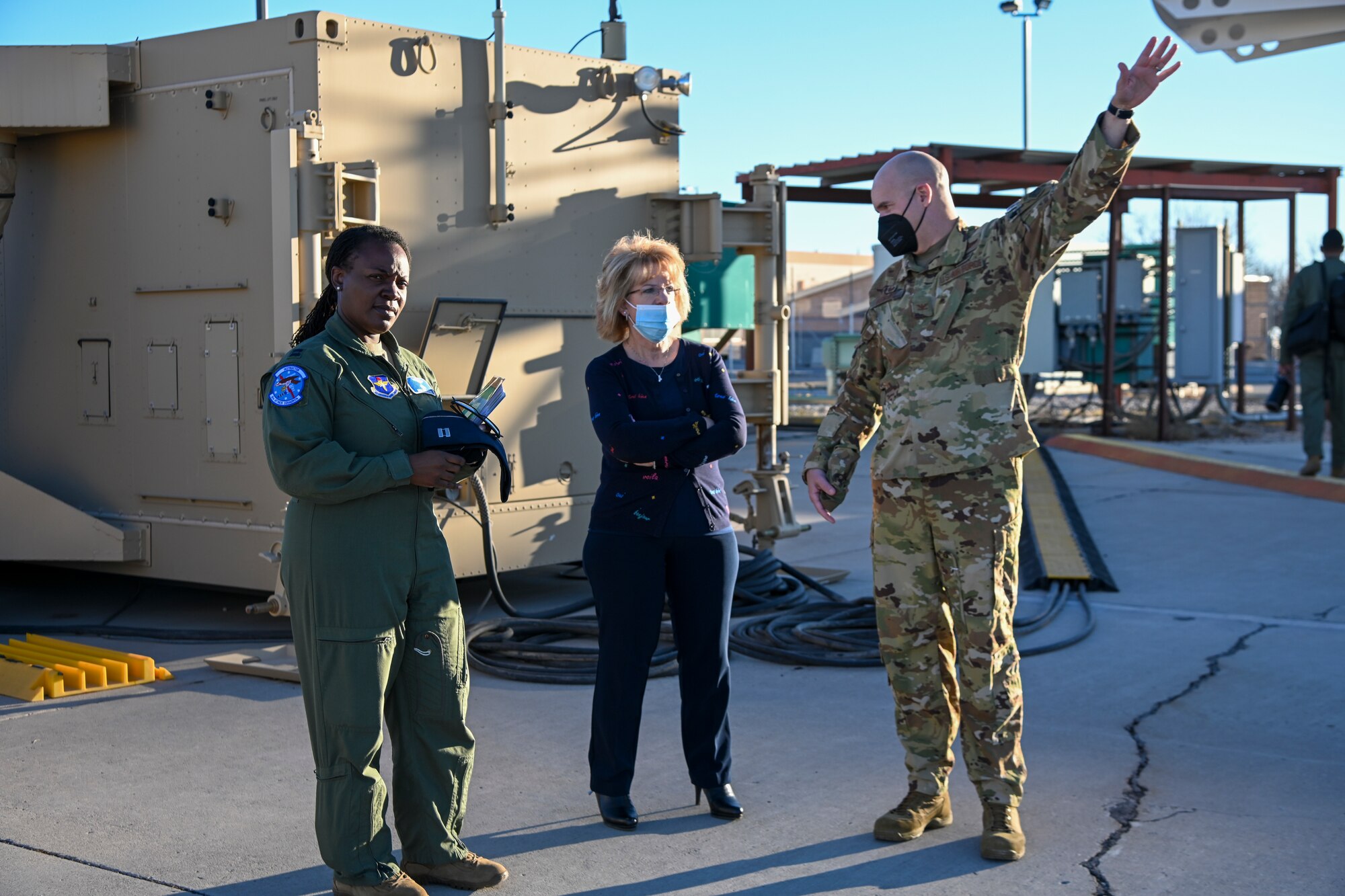 Capt. Anthokira Izelu-Dobbs, left, 6th Attack Squadron MQ-9 Reaper pilot, and Col. Ryan Keeney, right, 49th Wing commander, give Susan Payne, center, Mayor of Alamogordo, New Mexico, a tour of the 49th Operations Group MQ-9 cockpit yard, Feb. 7, 2022, on Holloman Air Force Base, New Mexico. Payne is the new mayor of Alamogordo and the new honorary 49th Wing Commander. (U.S. Air Force photo by Airman 1st Class Jessica Sanchez-Chen)