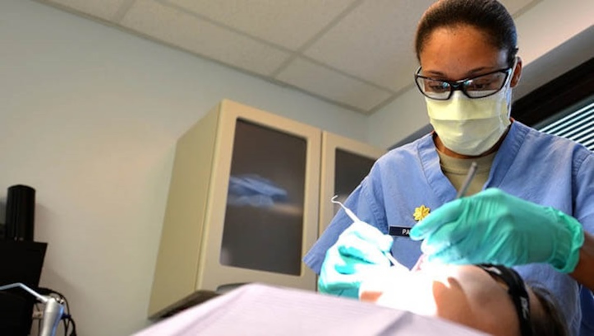 U.S. Air Force Major Rachael Parrish, 20th Dental Squadron general dentist, performs an oral exam on Airman 1st Class Amie Bickford, 20th Equipment Maintenance Squadron munitions technician at Shaw Air Force Base, South Carolina, March 13, 2017. Airmen assigned to the 20th DS are tasked with ensuring airmen and soldiers on base meet all dental class requirements for deployment (Airman 1st Class Christopher Maldonado, 20th Fighter Wing Public Affairs).