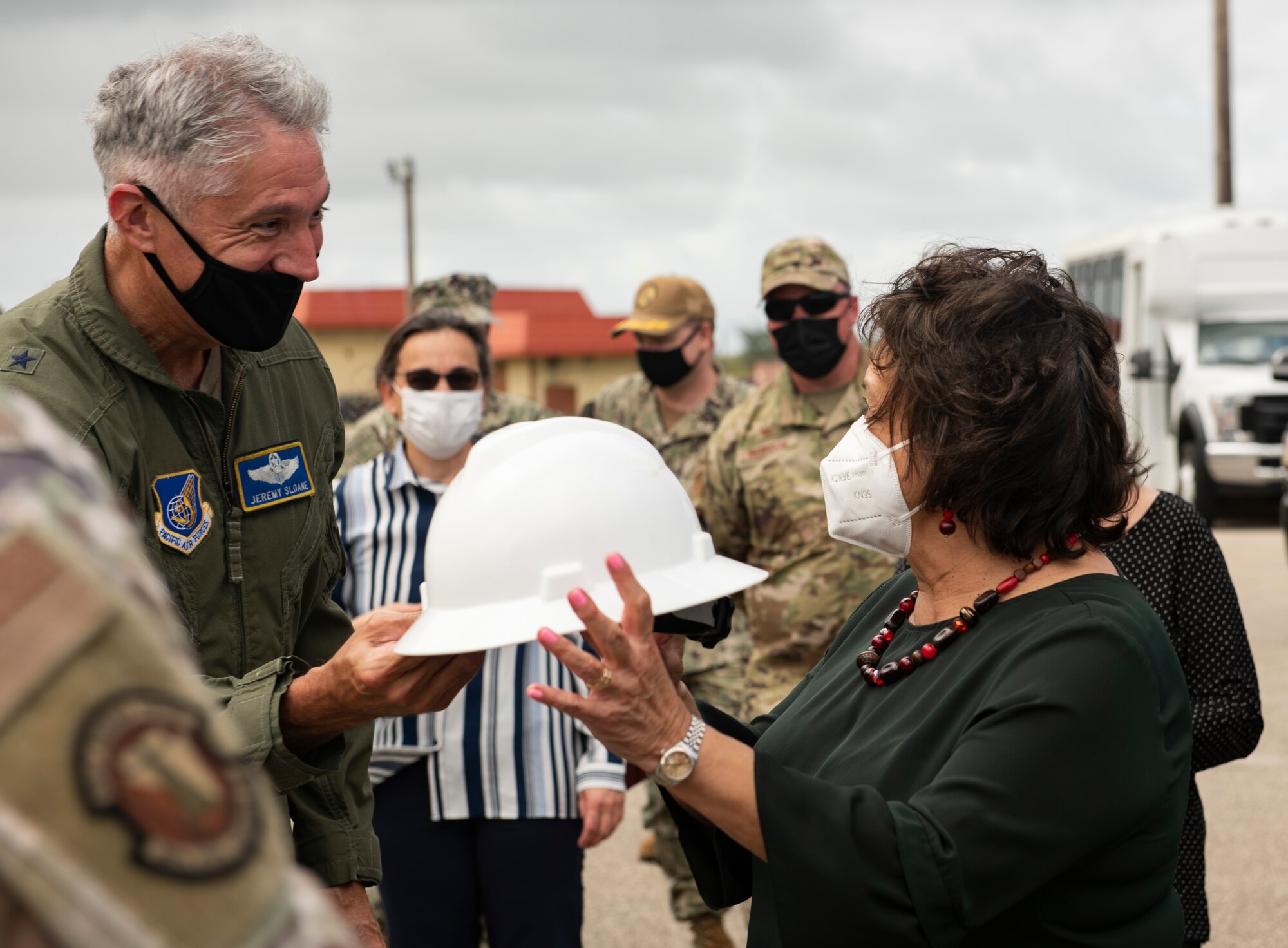 U.S. Air Force Brig. Gen. Jeremy Sloane, commander of the 36th Wing, Andersen Air Force Base, Guam, hands the Governor of Guam, Lou Leon Guerrero, a hard hat during a fuel farm visit February 8, 2022, at Andersen AFB. The visit highlighted the 36th Wing’s Spill Prevention, Control, and Countermeasure Plans that are currently in place in the event of an internal or external fuel spill on base. Additionally, visitors were shown several recently refurbished bulk storage tanks that demonstrate the significant progress made to re-emphasize the 36th Wing’s commitment to safe fuel operations as well as to recapitalize fuel infrastructure for many years to come.