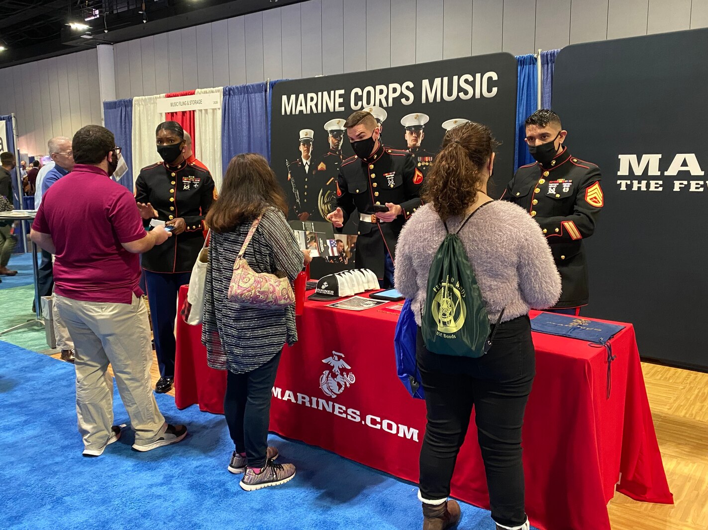 SSgt. Mardia Timoney, 6th Marine Corps District, Musician Technical Assistant, SSgt. Christian Guin, drum major, Parris Island Marine Corps Band, and Lance Cpl. Wolfgang Lynn, guitarist, Marine Forces Reserve Band, educate attendees of the Florida Music Education Association, Professional Development Conference about the Marine Corps Music Program in Tampa, Florida, Jan. 5 2022. The FMEA is one of the largest music education professional development event In the United States. (Photo by Sgt. Erin Morejon)
