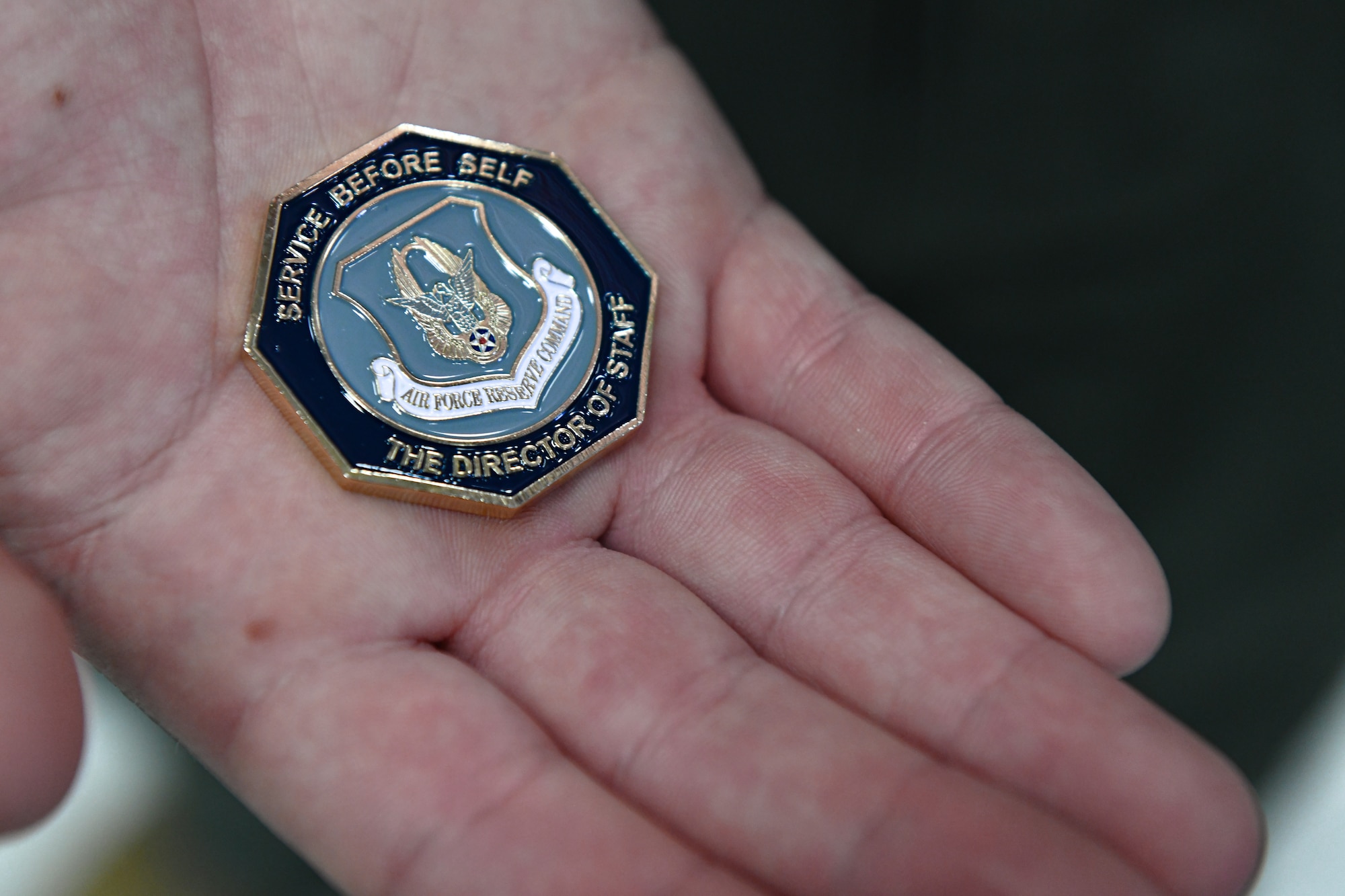 Senior Airman Alexander Markowitz, a flight engineer with the 757th Airlift Squadron, holds a coin on Feb. 6, 2022, at Youngstown Air Reserve Station, Ohio.