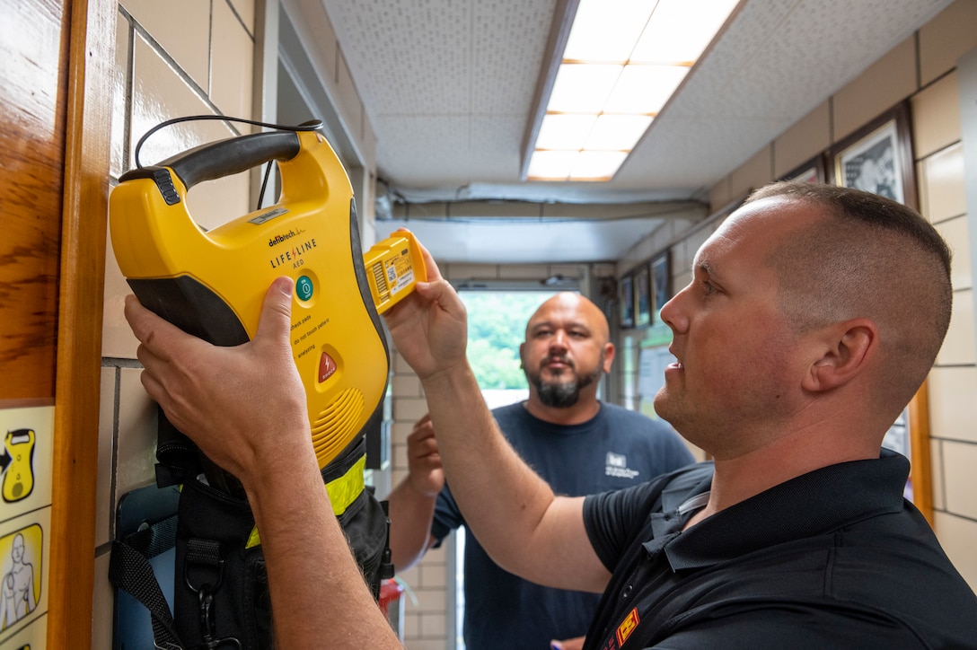 Matt Ehrin, a safety specialist with the U.S. Army Corps of Engineers Pittsburgh District, and Jason Moats, a collateral duty safety officer, check a defibrillator during a safety inspection at the Opekiska Lock and Dam in Morgantown, West Virginia, June 3, 2021.
