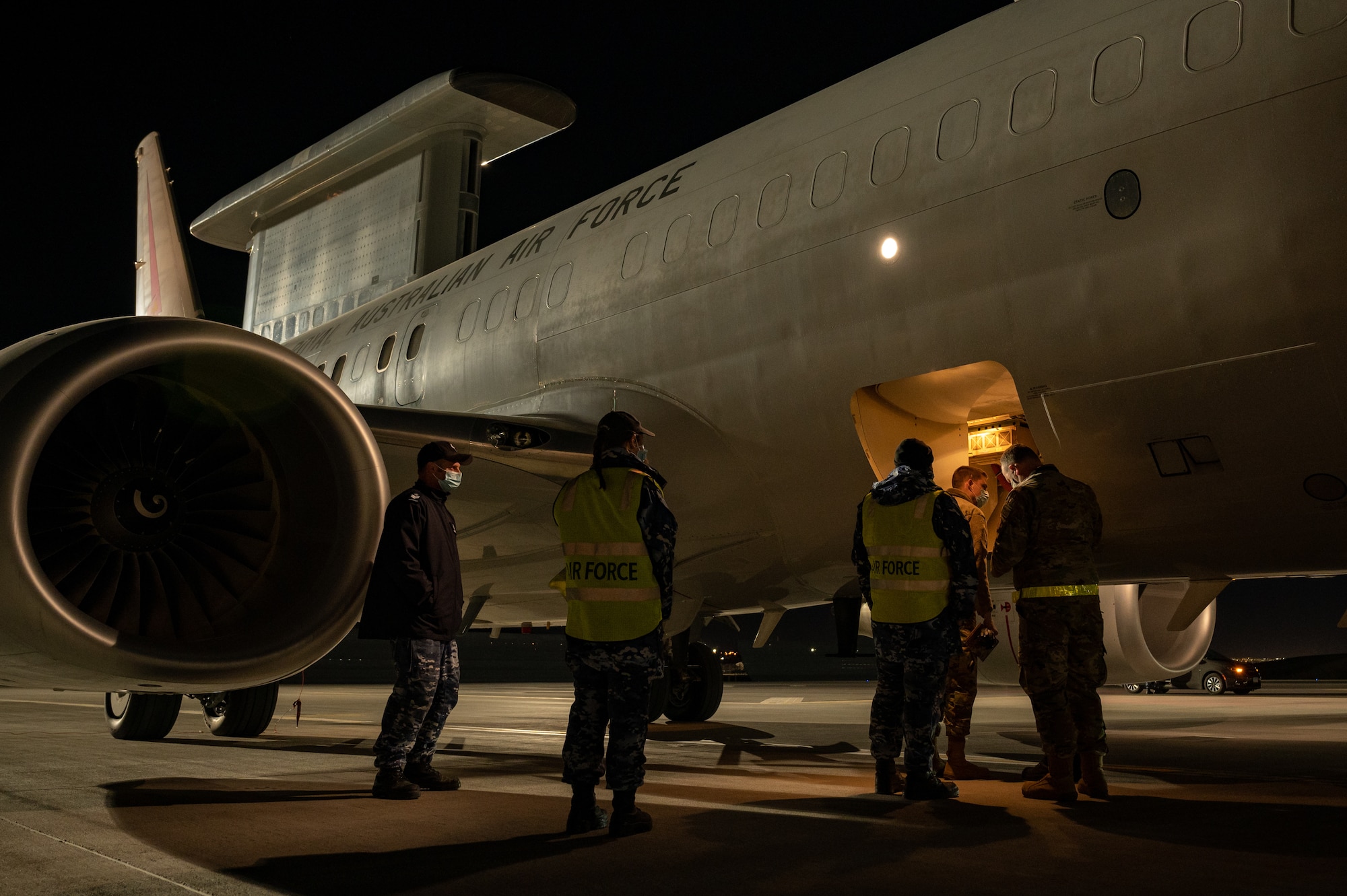 people standing in front of airplanes