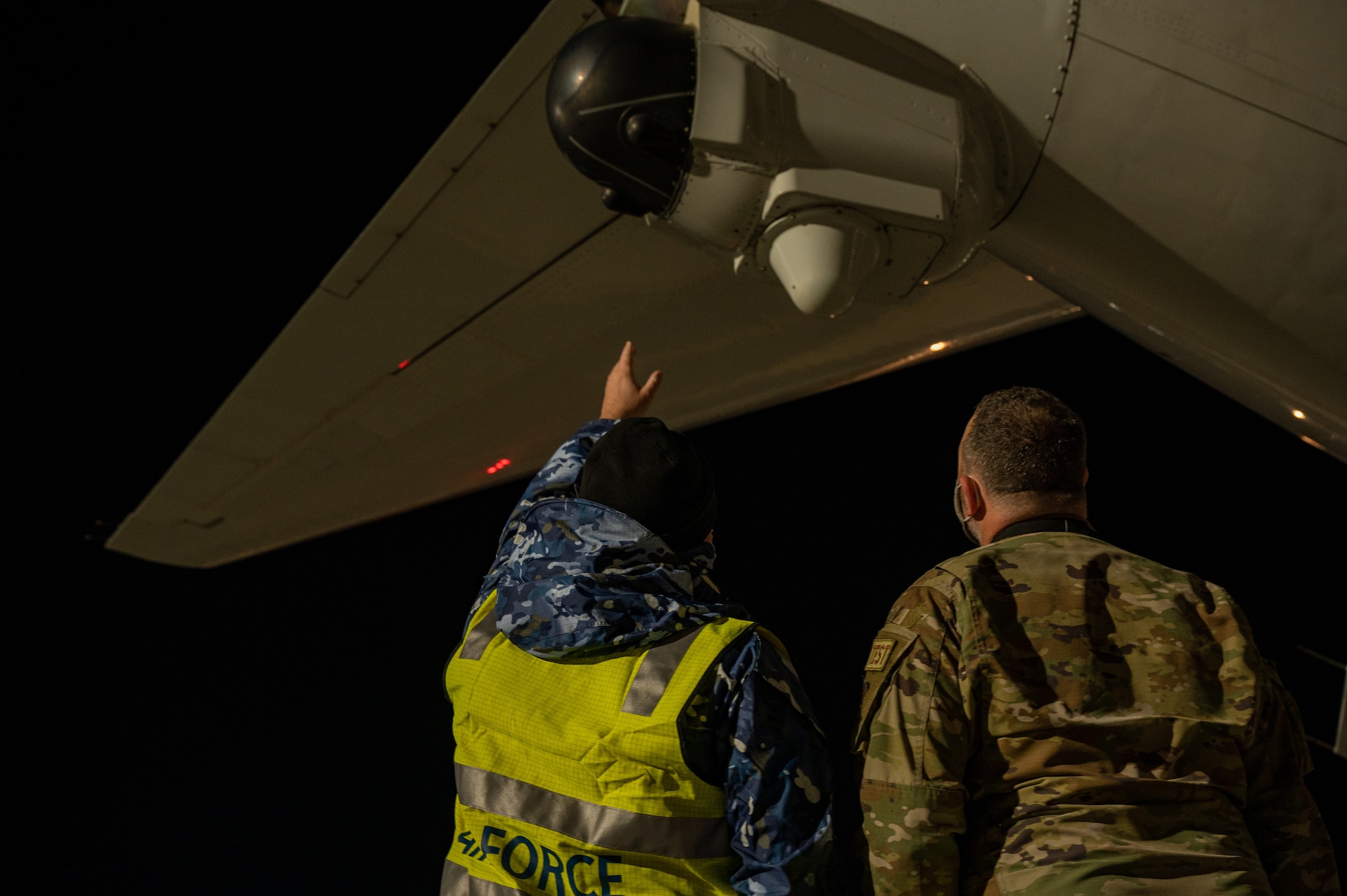 people standing in front of airplanes