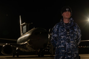 Guy standing in front of airplane