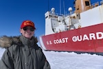 U.S. Coast Guard Lt. j.g. Lauren Kowalski, assistant operations officer aboard Coast Guard Cutter Polar Star (WAGB 10), stands in front of the Polar Star during ice liberty as the cutter transits toward Antartica, Jan. 7, 2022. Kowalski is the recipient of the Hopley Yeaton Superior Cutterman of the Year Award and was selected for her efforts in the ice pilot program, which saw her deploy aboard several U.S. Coast Guard and Royal British Navy icebreakers. (U.S. Coast Guard Photo by Petty Officer 3rd Class Diolanda Caballero)