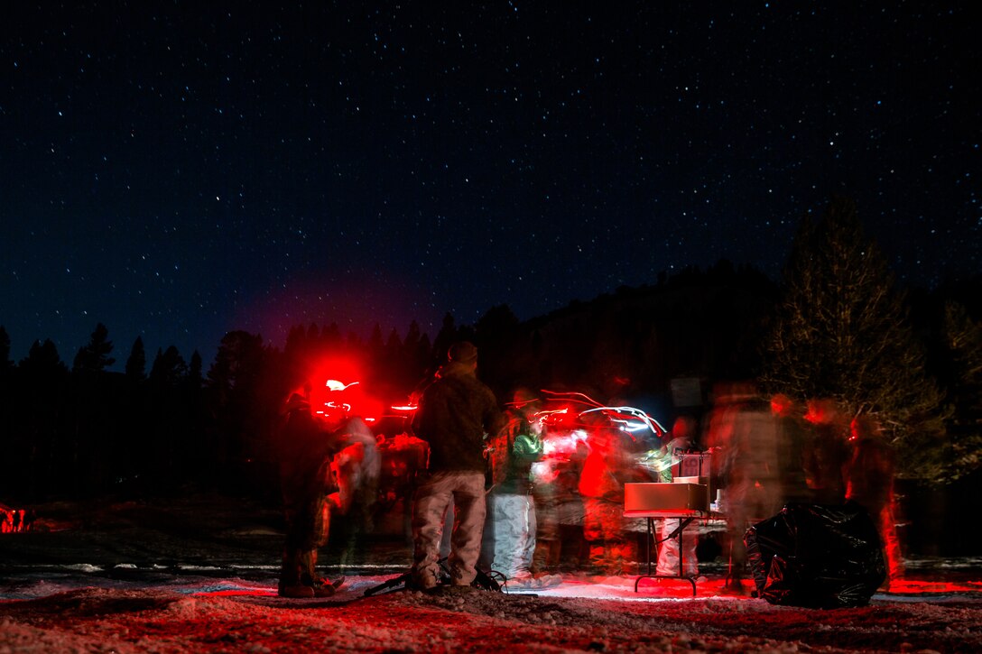 A group of Marines stand in line outside to get food.