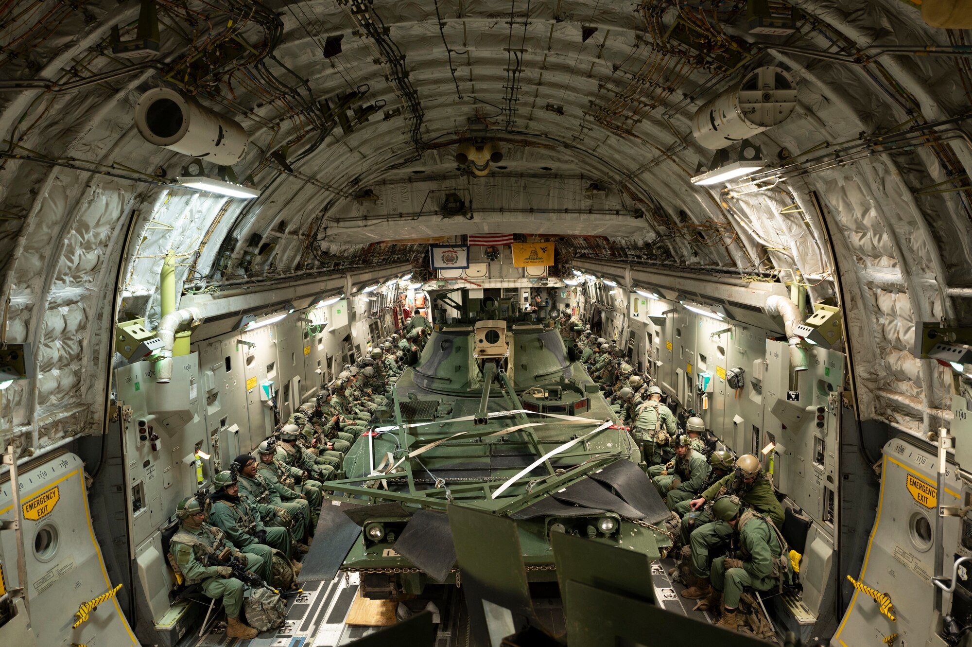 Over 50 U.S. Army soldiers destined for a landing zone in Ft. Polk, Louisiana, await takeoff while on a 167th C-17 Globemaster III aircraft with several military land vehicles during exercise Green Flag Little Rock 22-03 at Alexandria International Airport, Louisiana, Jan. 10, 2022. GFLR 22-03 focused on three joint-accredited items: combat airlift; survival, evasion, resistance and escape; and aeromedical evacuation.