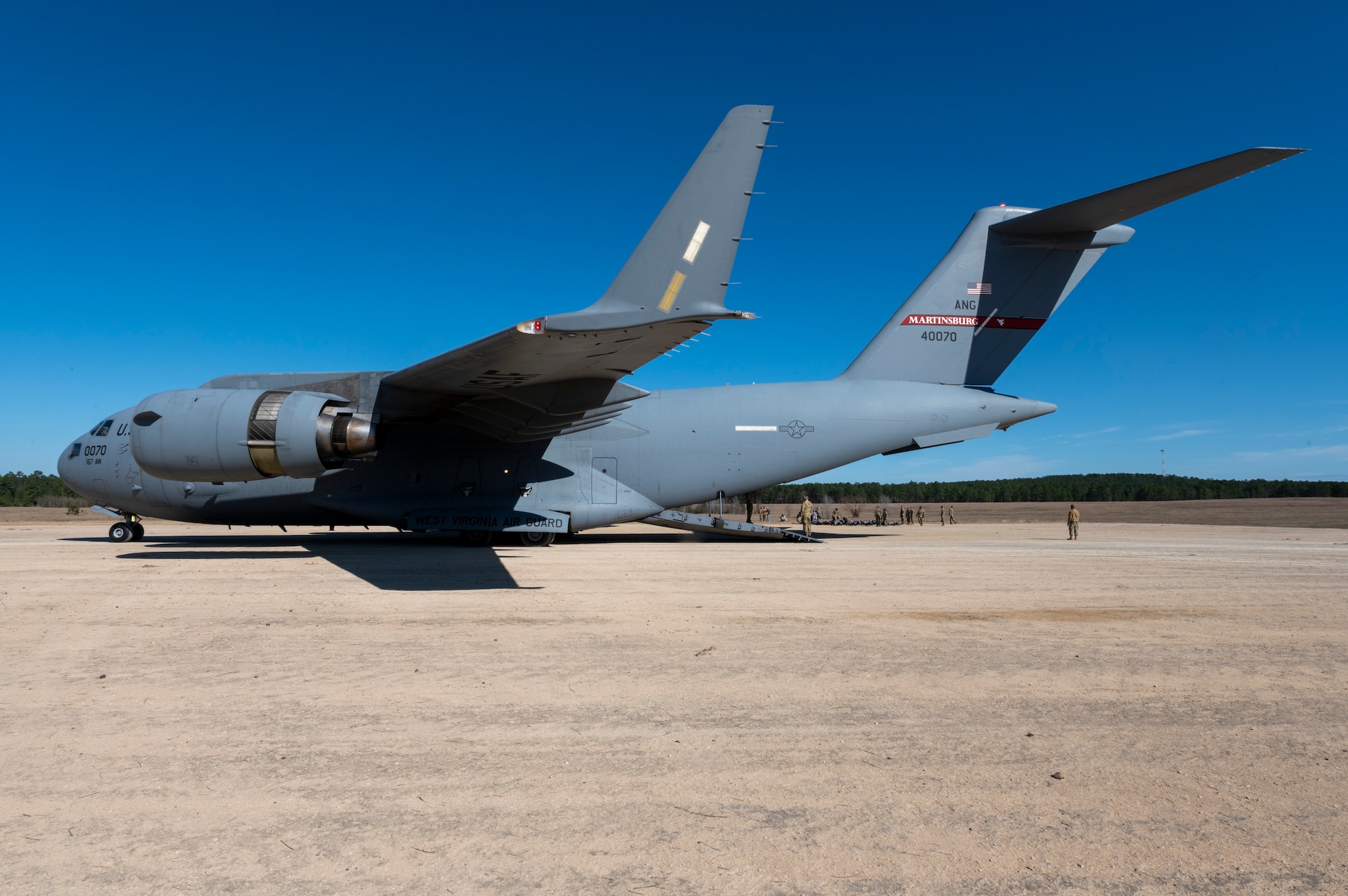 A 167th Airlift Wing C-17 Globemaster III aircraft awaits medical evacuation passengers on a semi-prepared runway during exercise Green Flag Little Rock 22-03 at Ft. Polk, Louisiana, Jan. 13, 2022. GFLR 22-03 focused on three joint-accredited items: combat airlift; survival, evasion, resistance and escape; and aeromedical evacuation