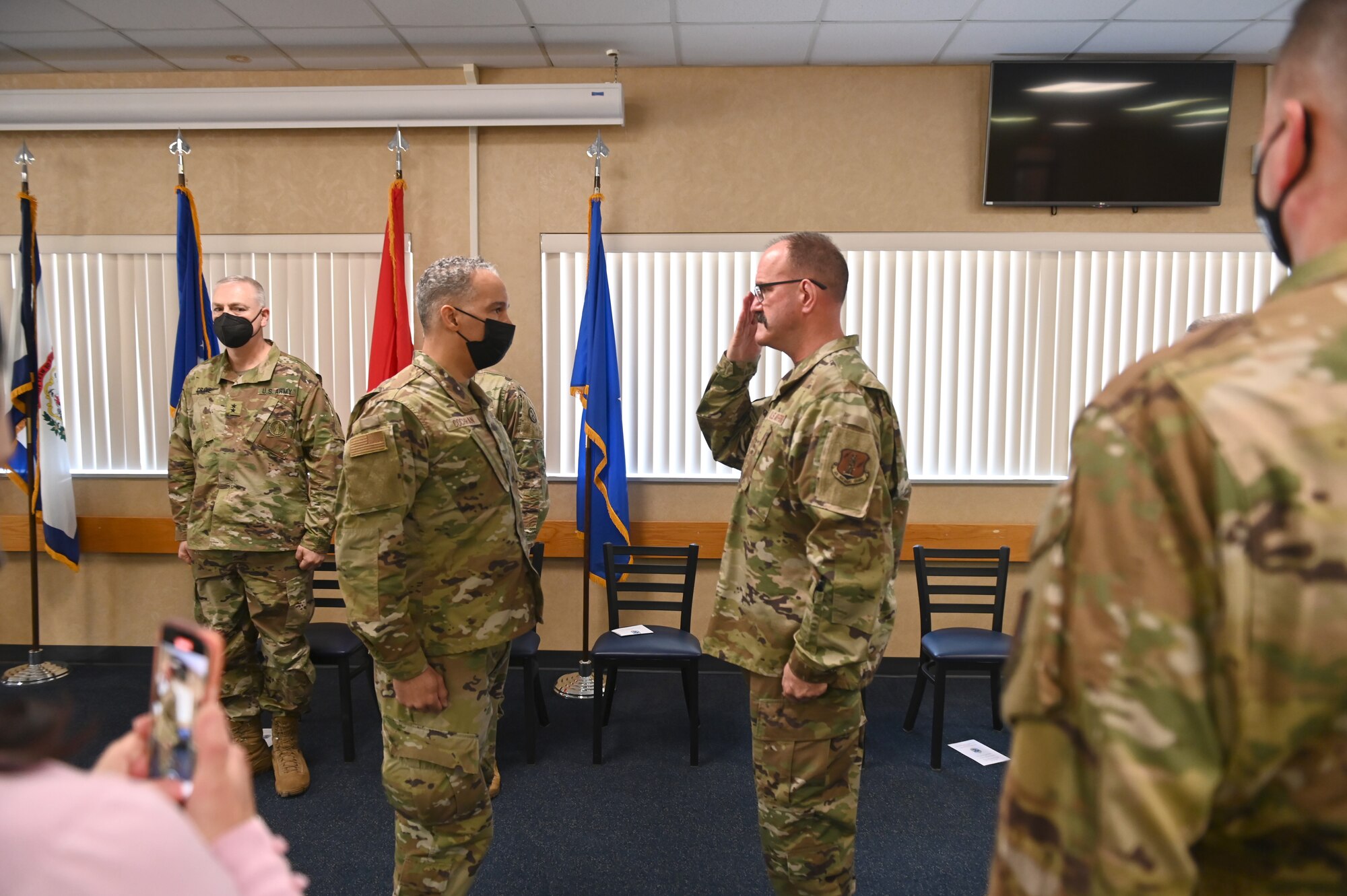 Chief Master Sgt. David Stevens gives his final salute as West Virginia Air National Guard state command chief to Brig. Gen. David Cochran, assistant adjutant general-Air, West Virginia National Guard, during a state command chief change of responsibility ceremony at the 167th Airlift Wing dining facility, Martinsburg, West Virginia, Feb. 5, 2022. The ceremony was held to mark the transition of the West Virginia Air National Guard state command from Chief Master Sgt. David Stevens to Chief Master Sgt. Brandon Ives.
