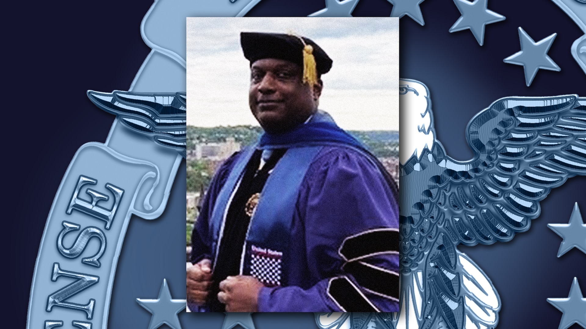 Black man stands outside in college graduation attire.