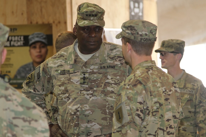 An army officer meets with troops.