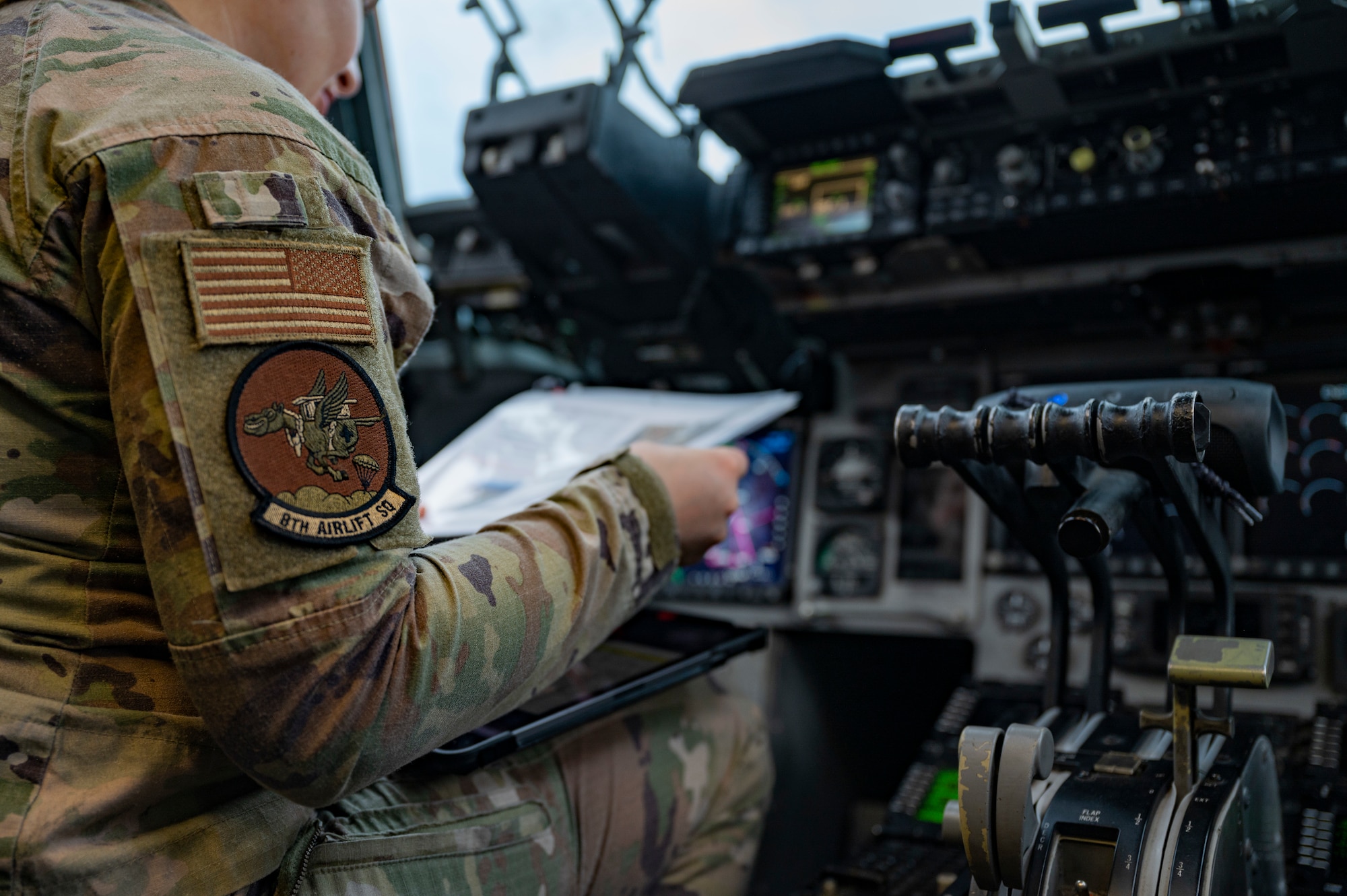 U.S. Air Force Capt. Sierra Kelly, a pilot with the 8th Airlift Squadron, conducts pre-flight checks prior to takeoff on a C-17 Globemaster III as part of Battalion Mass Tactical Week at Pope Army Airfield, North Carolina, Feb. 4, 2022. During mass-tactical week, Army and Air Force units work together to improve interoperability for worldwide crisis, contingency and humanitarian operations. (U.S. Air Force photo by Airman 1st Class Charles Casner)