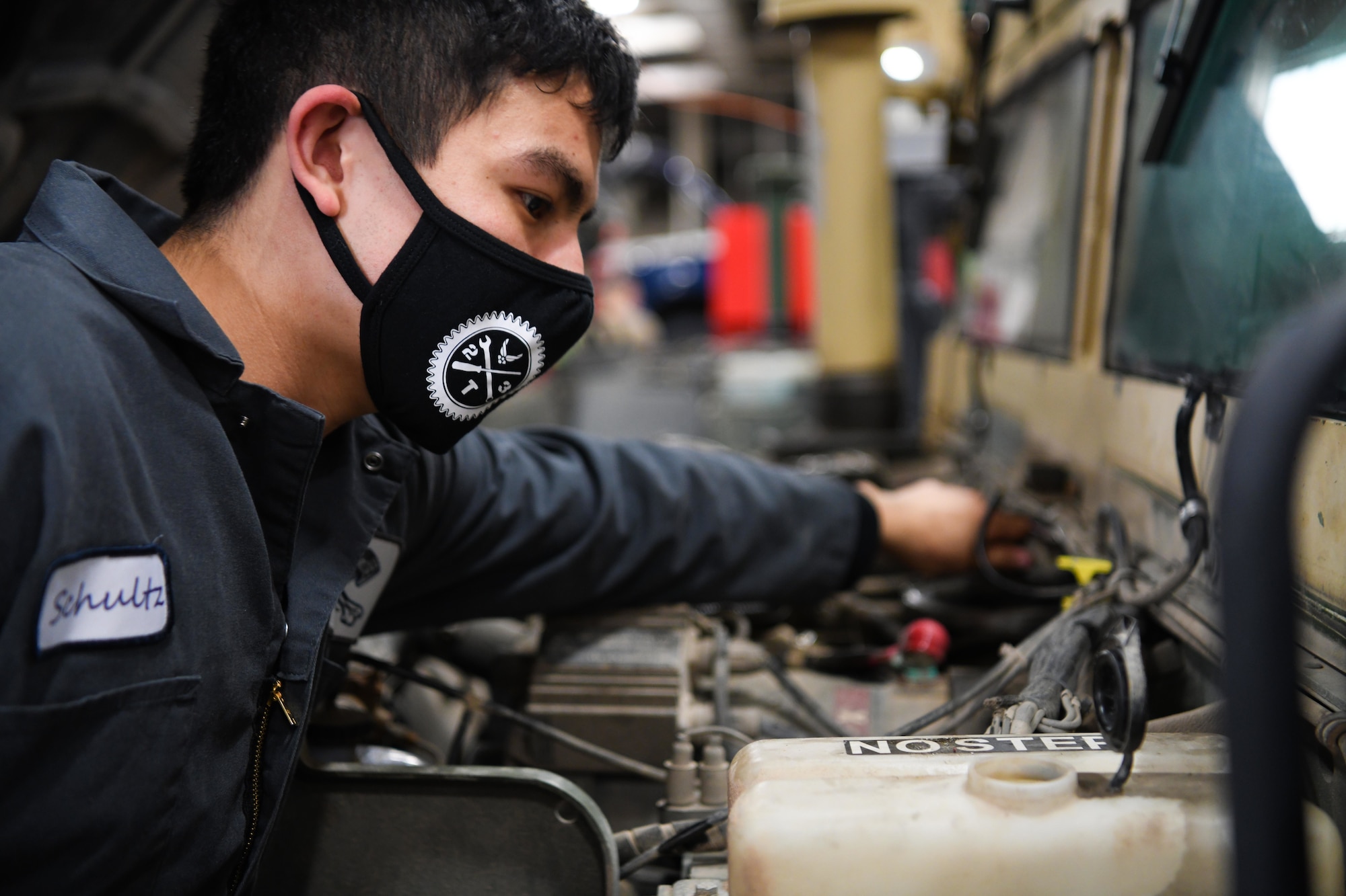 Airman 1st Class Indigo Schultz, mission generation vehicular equipment maintenance technician at the 90th Logistics Squadron, conducts a preventative maintenance inspection on a Humvee at the 90 LRS Vehicle Maintenance Flight warehouse on F.E. Warren Air Force Base, Wyoming, Feb. 8, 2022. PMIs are conducted to ensure vehicles are in working order after set intervals of time. The Vehicle Maintenance Flight is responsible for maintaining and repairing vehicles used in the mission of strategic nuclear deterrence. (U.S. Air Force photo by Airman 1st Class Charles Munoz)