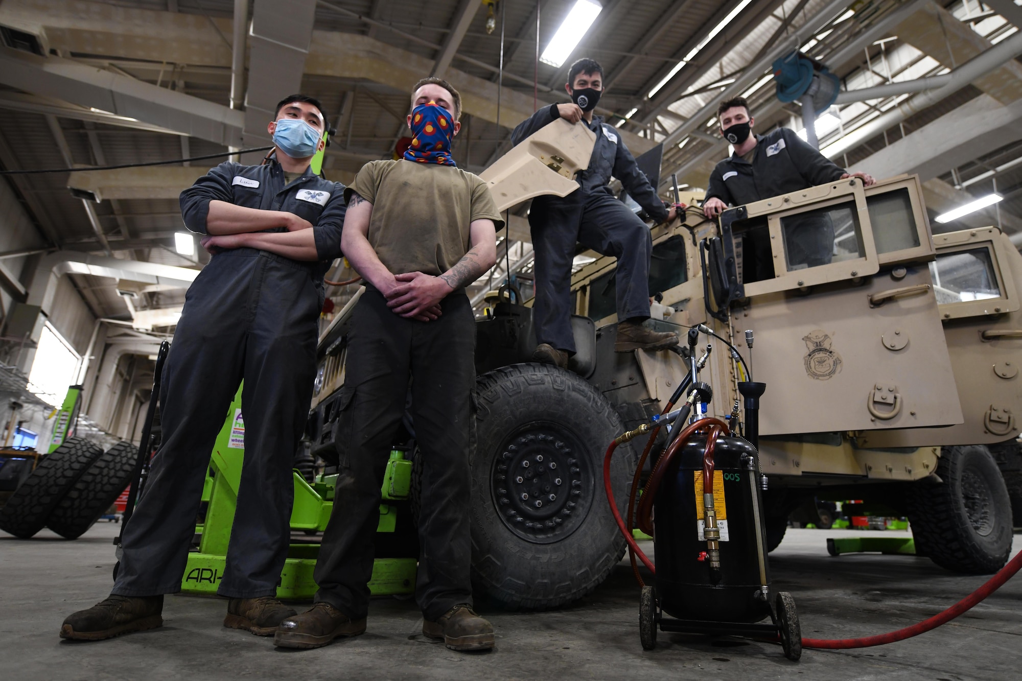 Airmen from the 90th Logistics Squadron pose with a Humvee at the 90 LRS Vehicle Maintenance Flight warehouse on F.E. Warren Air Force Base, Wyoming, Feb. 8, 2022. The Vehicle Maintenance Flight is responsible for maintaining and repairing vehicles operated on base to be used in the mission of strategic nuclear deterrence. (U.S. Air Force photo by Airman 1st Class Charles Munoz)