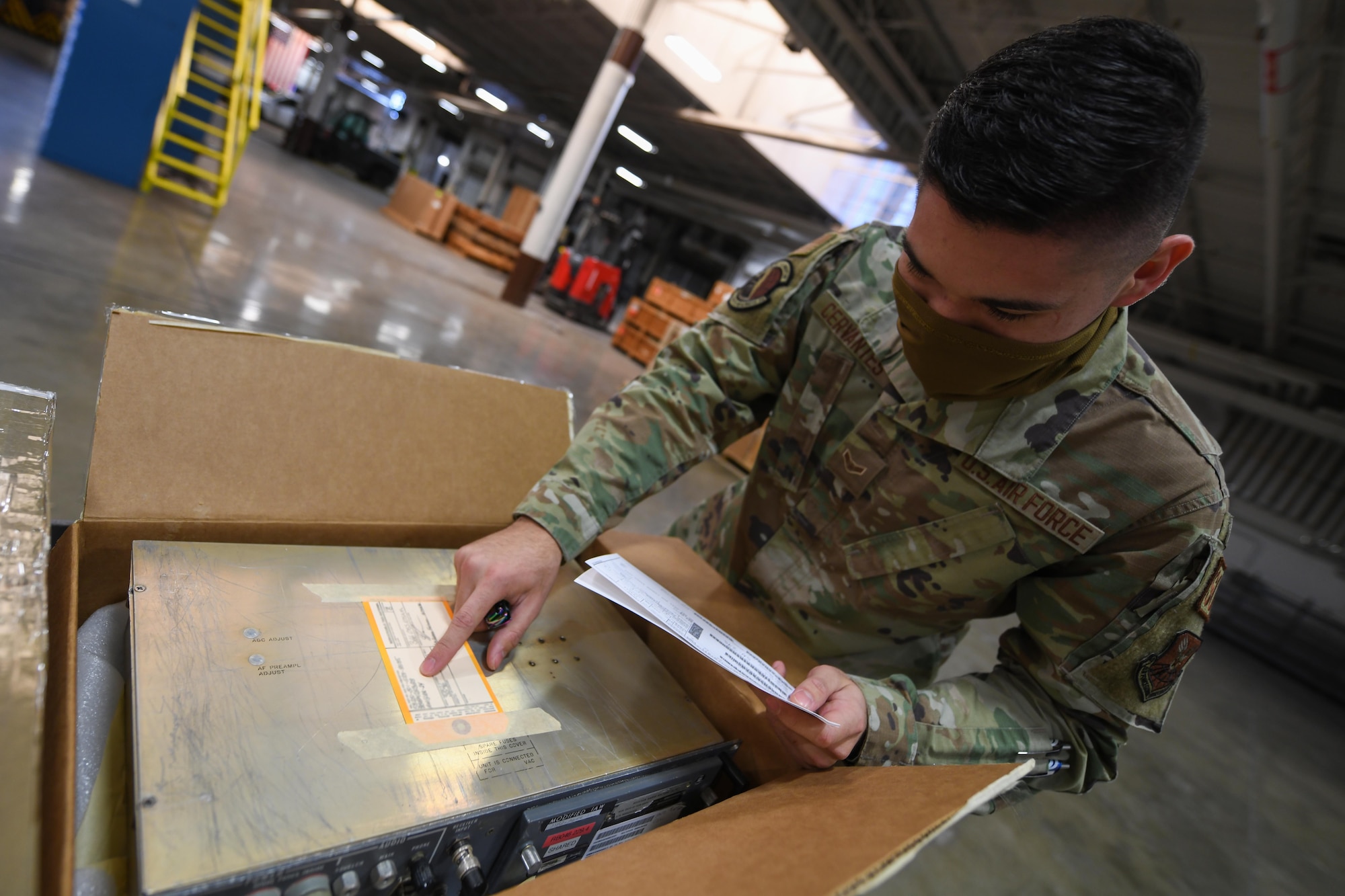 Airman 1st Class Atruro Cervantes, supply technician assigned to the 90th Logistics Readiness Squadron, analyzes a radio in the Military Personnel Flight building on F.E. Warren Air Force Base, Wyoming, Feb. 9, 2022. The 90 LRS Material Management Flight must inspect incoming boxes to ensure they have received the correct assets and quantities. These assets are distributed throughout F.E. Warren AFB to support the mission of strategic nuclear deterrence. (U.S. Air Force photo by Airman 1st Class Charles Munoz)
