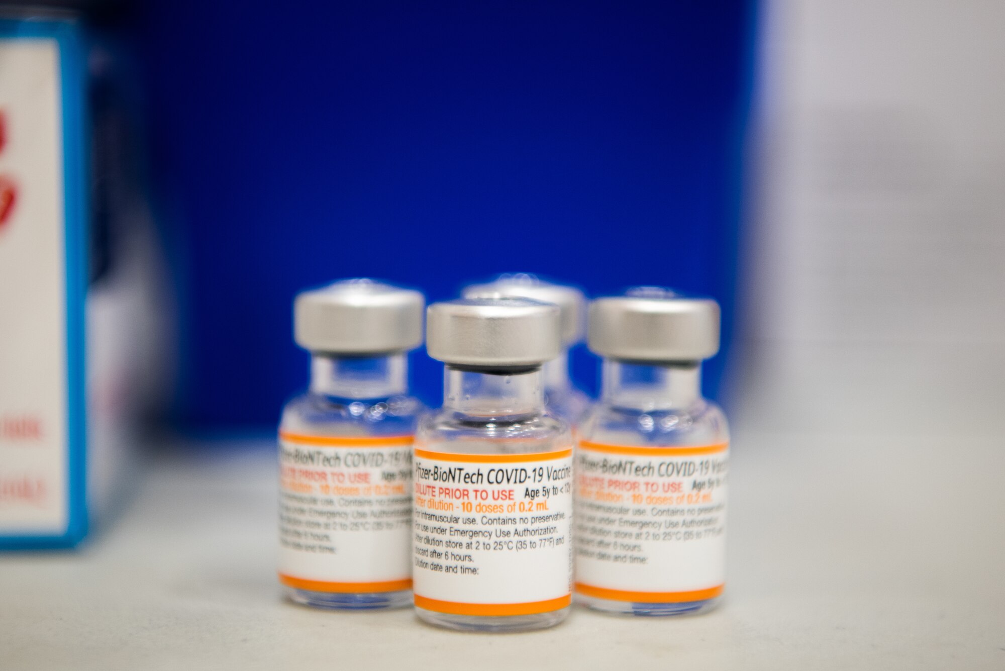 Vials of COVID-19 vaccine sit on a table.