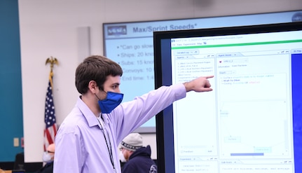 IMAGE: Naval Surface Warfare Center Dahlgren Division Engineer Gary Pepper answers questions about the Modeling and Simulation Toolbox (MAST) model during a hackathon event, Jan. 27. The hackathon saw a “friendly competition between departments,” according to Pepper.