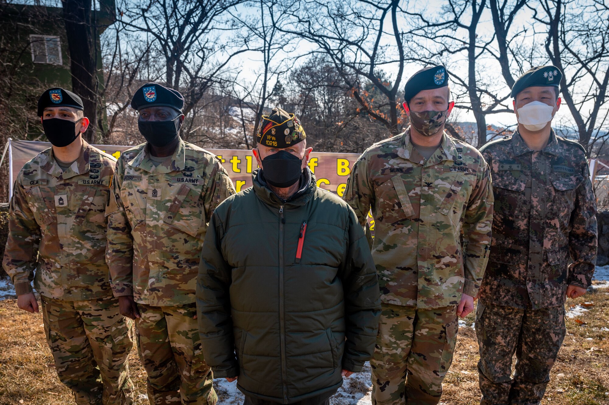 Earnest Lee, Korean War veteran and Hill 180 remembrance ceremony distinguished guest, poses for a photo with members of the 3rd Battlefield Coordination Detachment-Korea