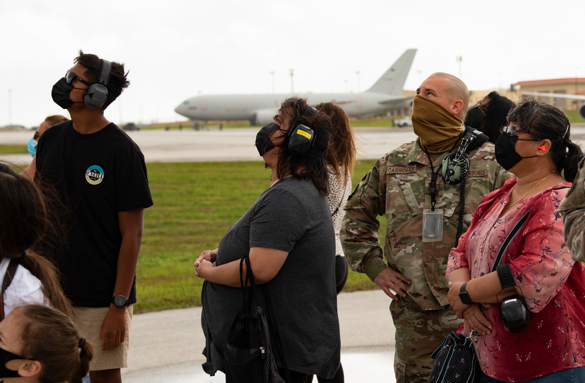 Mayor of Dededo, Melissa Savares (right), watches as aircraft take-off from Andersen Air Force Base during Exercise Cope North 22, Feb. 9, 2022. Service members, their families and civic leaders were invited to the flight line to learn the importance of Cope North while observing aircraft capabilities.  Exercise Cope North is the U.S. Pacific Air Forces’ largest multilateral exercise and includes more than 2, 500 U.S. Airmen, Marines, and Sailors working alongside 1,000 combined Japan Air Self-Defense Force and Royal Australian Air Force counterparts.