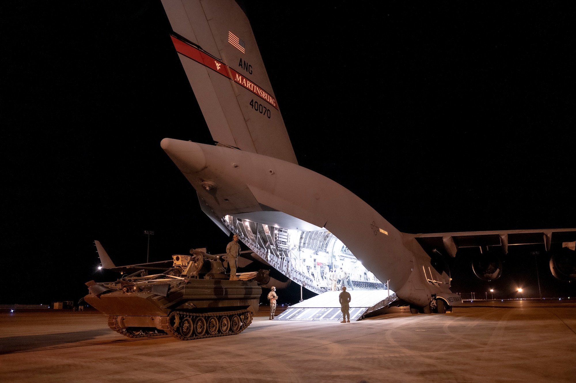 U.S. Air Force and U.S. Army personnel upload a 167th C-17 Globemaster III aircraft with a modified M113 armored personnel carrier during exercise Green Flag Little Rock 22-03 at Alexandria International Airport, Louisiana, Jan. 10, 2022. GFLR 22-03 focused on three joint-accredited items: combat airlift; survival, evasion, resistance and escape; and aeromedical evacuation.