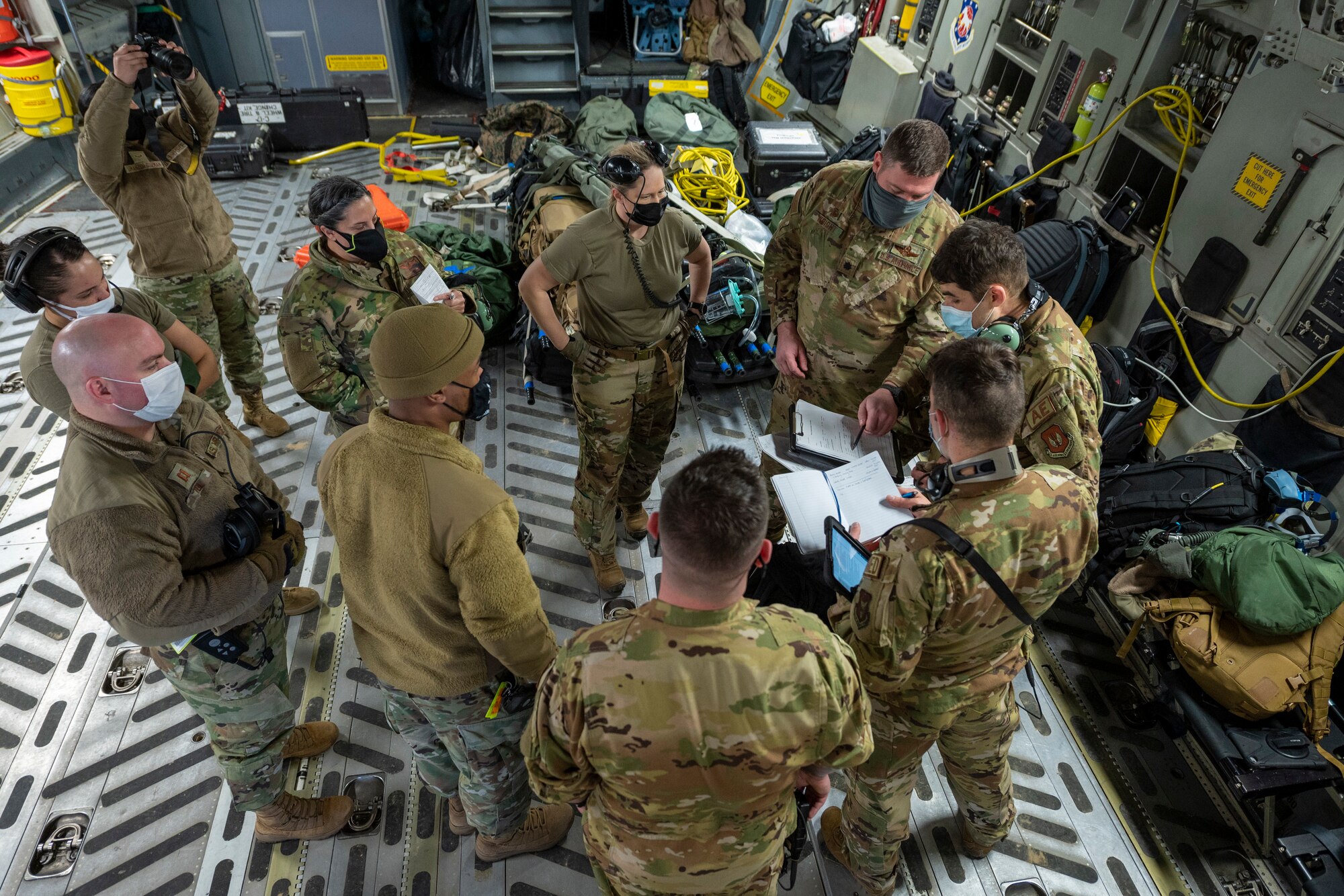 A group consisting mainly of U.S. Air Force aeromedical evacuation airmen attend a flight safety briefing shortly before takeoff of a 167th Airlift Wing C-17 Globemaster III aircraft during exercise Green Flag Little Rock 22-03 at Little Rock Air Force Base, Jacksonville, Arkansas, Jan. 13, 2022. GFLR 22-03 focused on three joint-accredited items: combat airlift; survival, evasion, resistance and escape; and aeromedical evacuation.